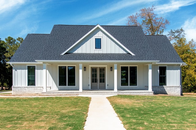 4935 Ward Bend Rd, Sealy, TX 77474 - modern farmhouse style home featuring board and batten siding, covered porch, and a front lawn