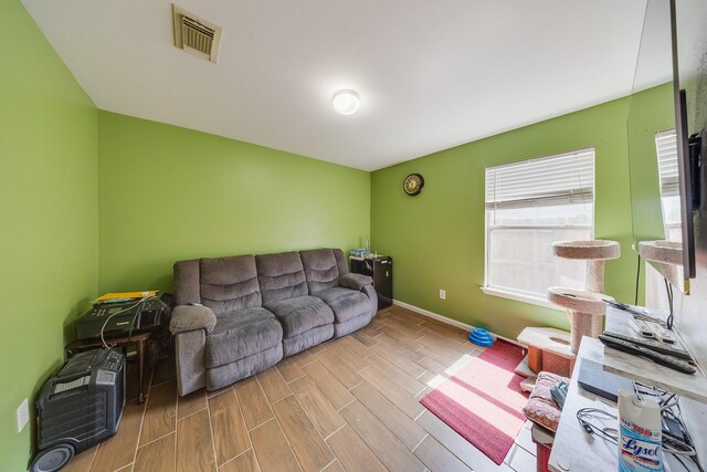 2707 Trementina Dr, Houston, TX 77088 - living area featuring wood tiled floors and baseboards
