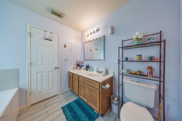 2707 Trementina Dr, Houston, TX 77088 - bathroom with vanity, wood tiled floors, and a bath