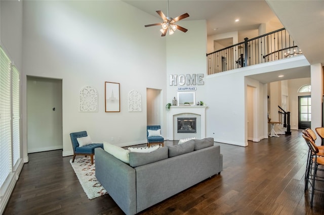 4209 Orchard Pass Dr, Spring, TX 77386 - living area featuring a high ceiling, stairs, dark wood-type flooring, and ceiling fan