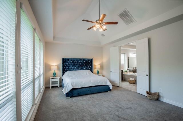 4209 Orchard Pass Dr, Spring, TX 77386 - carpeted bedroom featuring a raised ceiling, ensuite bath, and ceiling fan