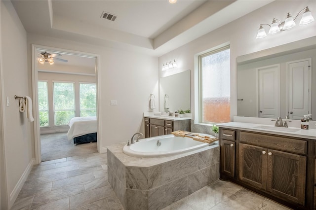 4209 Orchard Pass Dr, Spring, TX 77386 - bathroom with a garden tub, two vanities, a tray ceiling, and ensuite bath