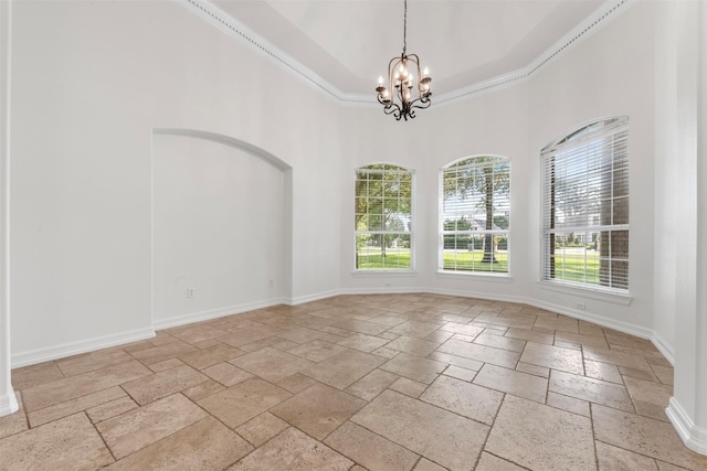 3207 W Benders Landing Blvd, Spring, TX 77386 - unfurnished room with stone tile flooring, a chandelier, a high ceiling, a tray ceiling, and ornamental molding
