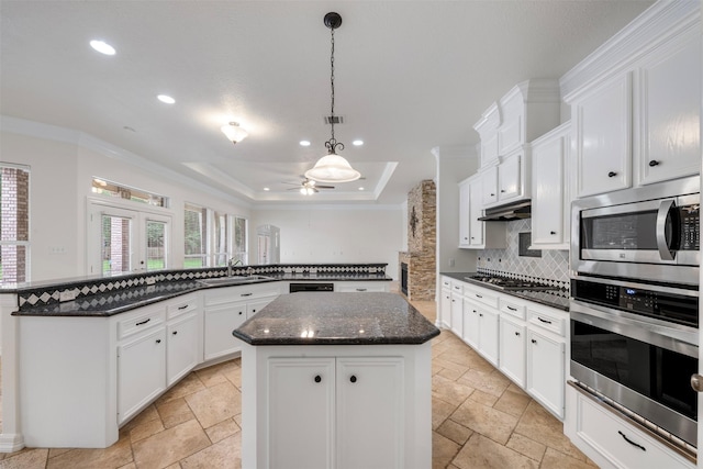 3207 W Benders Landing Blvd, Spring, TX 77386 - kitchen featuring appliances with stainless steel finishes, a center island, stone tile flooring, recessed lighting, and backsplash