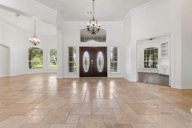 3207 W Benders Landing Blvd, Spring, TX 77386 - foyer featuring a chandelier, stone tile flooring, plenty of natural light, a towering ceiling, and crown molding