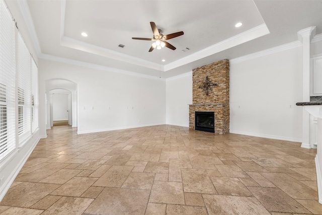 3207 W Benders Landing Blvd, Spring, TX 77386 - unfurnished living room featuring stone tile flooring, ceiling fan, a tray ceiling, a fireplace, and recessed lighting