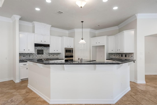 3207 W Benders Landing Blvd, Spring, TX 77386 - kitchen with appliances with stainless steel finishes, stone tile flooring, recessed lighting, under cabinet range hood, and tasteful backsplash