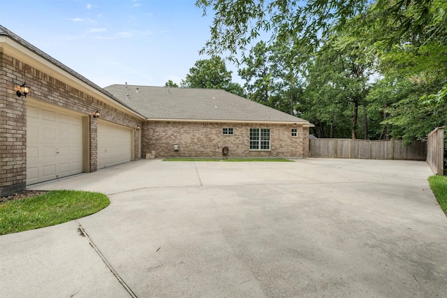 3207 W Benders Landing Blvd, Spring, TX 77386 - view of side of home with driveway, an attached garage, brick siding, and a shingled roof