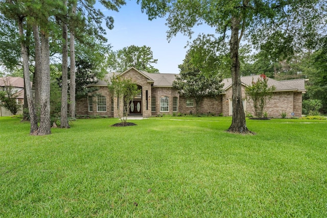 3207 W Benders Landing Blvd, Spring, TX 77386 - view of front facade with a front lawn and brick siding