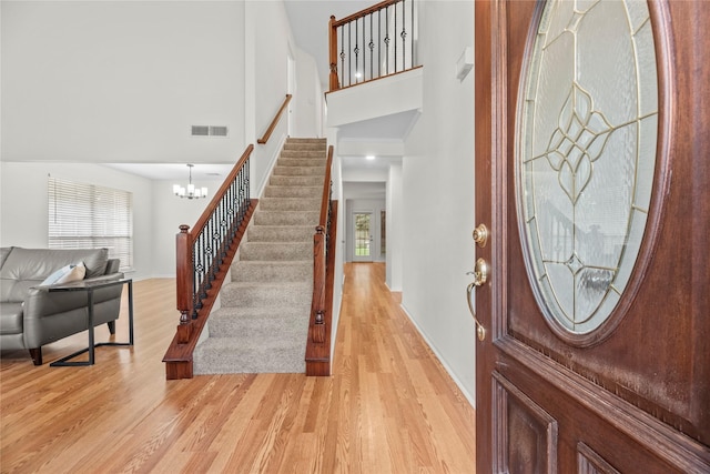 15207 Hillside Park Way, Cypress, TX 77433 - entryway with stairs, healthy amount of natural light, light wood-style flooring, a high ceiling, and a chandelier