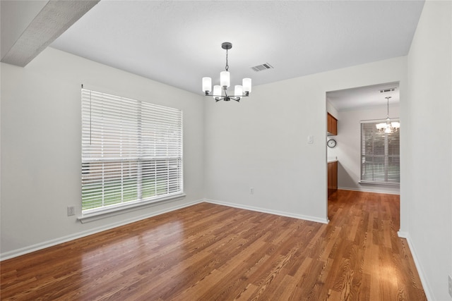15207 Hillside Park Way, Cypress, TX 77433 - empty room featuring a chandelier, wood finished floors, and healthy amount of natural light