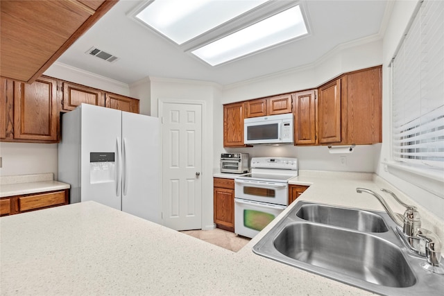 15207 Hillside Park Way, Cypress, TX 77433 - kitchen with white appliances, brown cabinets, ornamental molding, and light countertops