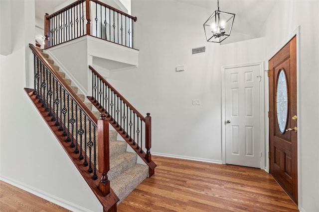 15207 Hillside Park Way, Cypress, TX 77433 - entryway with wood finished floors, a chandelier, a towering ceiling, and stairs