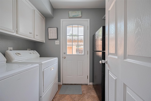 14666 Perthshire Rd Unit F, Houston, TX 77079 - laundry area with cabinet space, washing machine and dryer, and light tile patterned floors