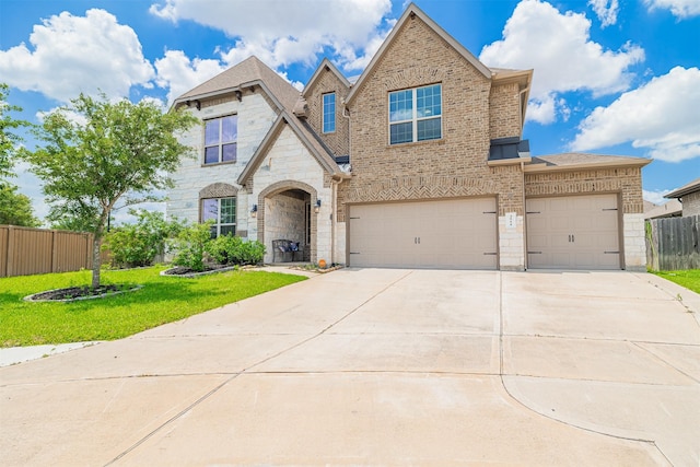 3514 Hampton Landing Ct, Katy, TX 77494 - view of front of house with brick siding, concrete driveway, stone siding, a garage, and an attached garage
