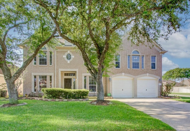 2210 Waters Edge Ln, League City, TX 77573 - view of front of property featuring driveway, a front yard, an attached garage, and brick siding