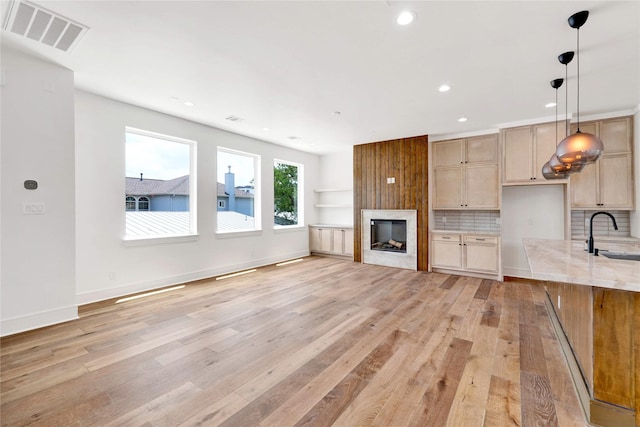 5439 Darling St, Houston, TX 77007 - unfurnished living room with light wood finished floors, recessed lighting, and a large fireplace