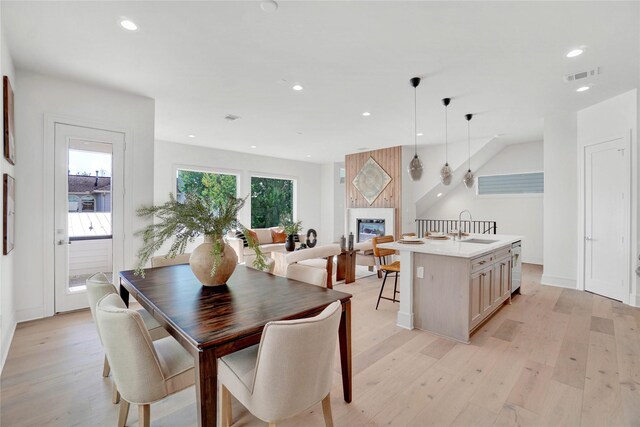 5439 Darling St, Houston, TX 77007 - dining room with light wood-type flooring, a fireplace, and recessed lighting