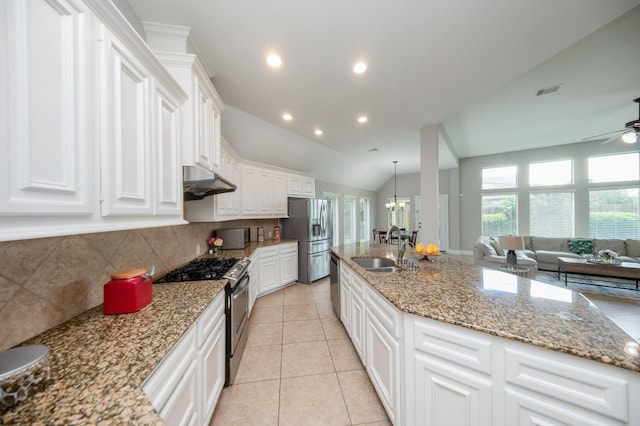 27907 Brandy Creek Ln, Fulshear, TX 77441 - kitchen featuring stainless steel appliances, backsplash, white cabinetry, a ceiling fan, and a chandelier
