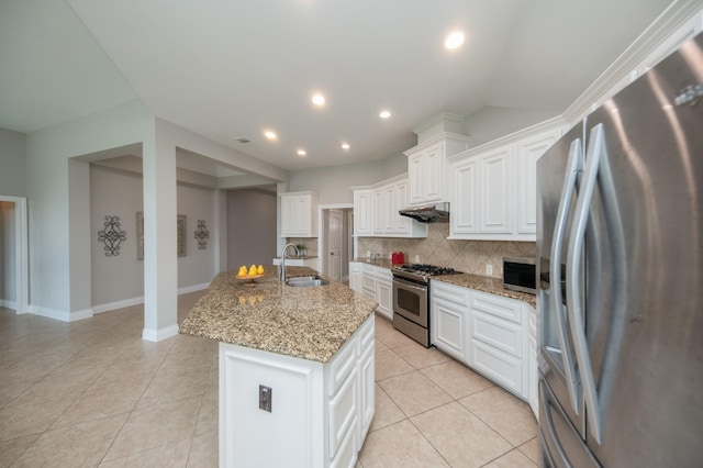 27907 Brandy Creek Ln, Fulshear, TX 77441 - kitchen featuring stainless steel appliances, decorative backsplash, light tile patterned floors, an island with sink, and light stone countertops