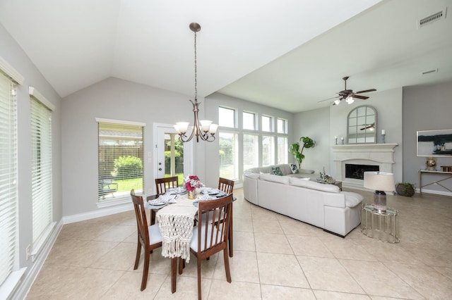 27907 Brandy Creek Ln, Fulshear, TX 77441 - dining room with light tile patterned floors, a chandelier, a fireplace, lofted ceiling, and ceiling fan
