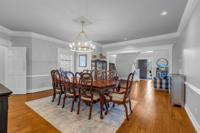 8723 Kennet Valley Rd, Spring, TX 77379 - dining space with a chandelier, light wood finished floors, and ornamental molding