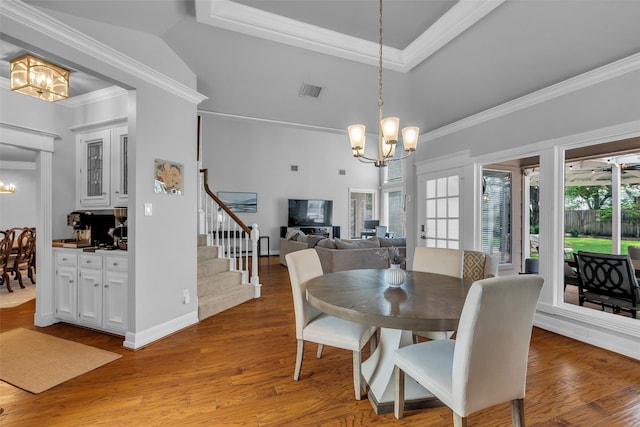 8723 Kennet Valley Rd, Spring, TX 77379 - dining room with a chandelier, stairway, wood finished floors, ornamental molding, and a tray ceiling