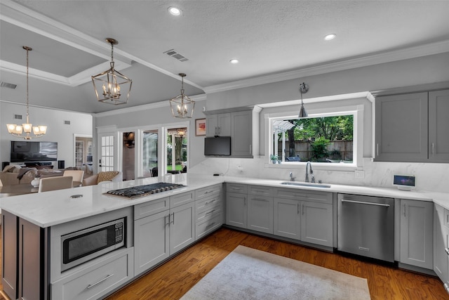 8723 Kennet Valley Rd, Spring, TX 77379 - kitchen featuring stainless steel appliances, a chandelier, gray cabinetry, a peninsula, and healthy amount of natural light
