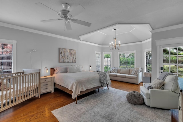 8723 Kennet Valley Rd, Spring, TX 77379 - bedroom featuring a chandelier, wood finished floors, multiple windows, crown molding, and a tray ceiling