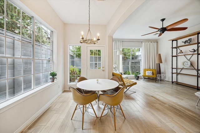 2019 Hazard St, Houston, TX 77019 - dining room with light wood-style flooring, a chandelier, a ceiling fan, and arched walkways