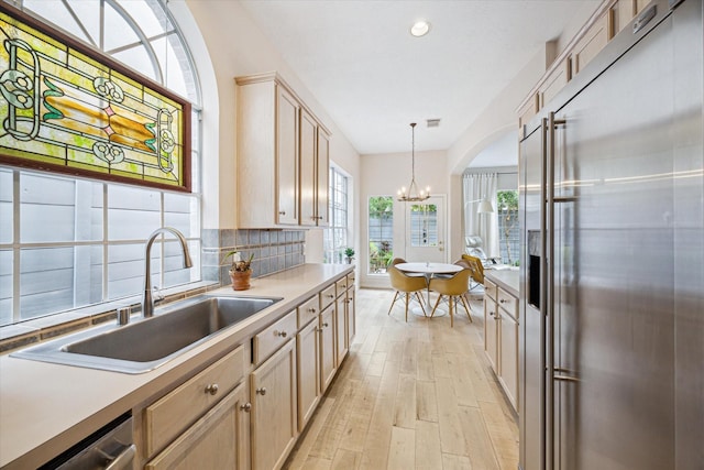 2019 Hazard St, Houston, TX 77019 - kitchen with stainless steel built in refrigerator, light wood-style flooring, a chandelier, decorative backsplash, and light brown cabinetry
