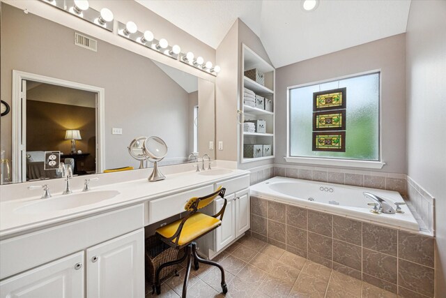 2019 Hazard St, Houston, TX 77019 - bathroom with double vanity, a whirlpool tub, ensuite bath, lofted ceiling, and tile patterned floors