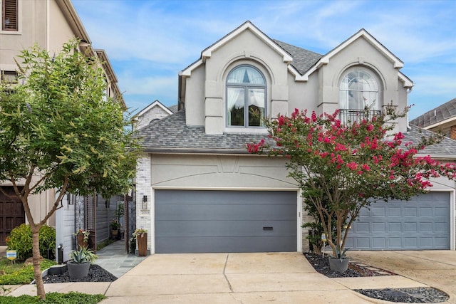 2019 Hazard St, Houston, TX 77019 - view of front facade with roof with shingles, concrete driveway, and stucco siding