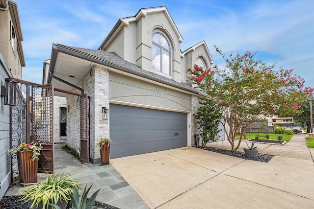 2019 Hazard St, Houston, TX 77019 - view of front of property with concrete driveway, a garage, and stucco siding