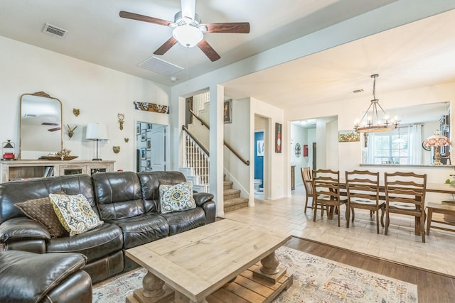 12602 Browning Dr, Montgomery, TX 77356 - living room with a ceiling fan, stairway, a chandelier, and wood finished floors