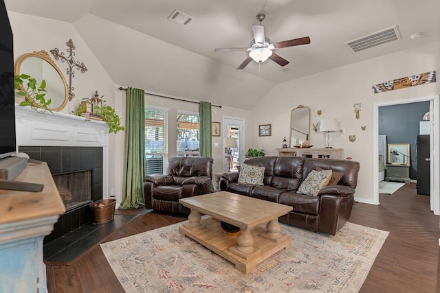 12602 Browning Dr, Montgomery, TX 77356 - living area with vaulted ceiling, ceiling fan, dark wood-type flooring, and a tile fireplace