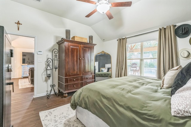 12602 Browning Dr, Montgomery, TX 77356 - bedroom with dark wood-style floors, vaulted ceiling, and a ceiling fan