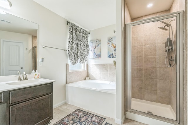 12602 Browning Dr, Montgomery, TX 77356 - full bath with a garden tub, a stall shower, vanity, and tile patterned flooring