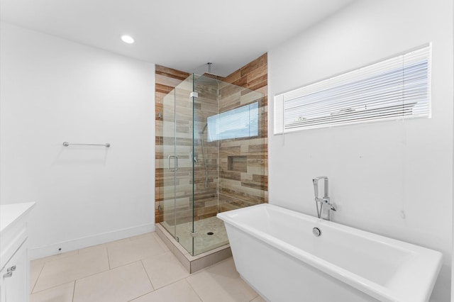 7722 Jacquelyn Oaks Rd, Houston, TX 77055 - bathroom with a freestanding bath, a shower stall, vanity, tile patterned floors, and recessed lighting