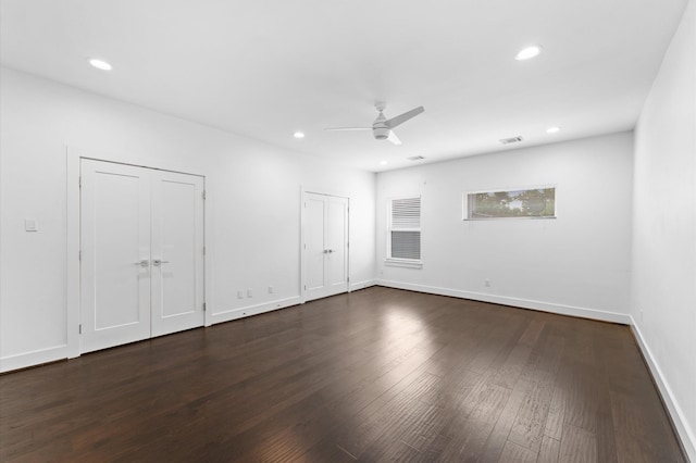 7722 Jacquelyn Oaks Rd, Houston, TX 77055 - unfurnished bedroom with multiple closets, recessed lighting, dark wood-style flooring, and ceiling fan