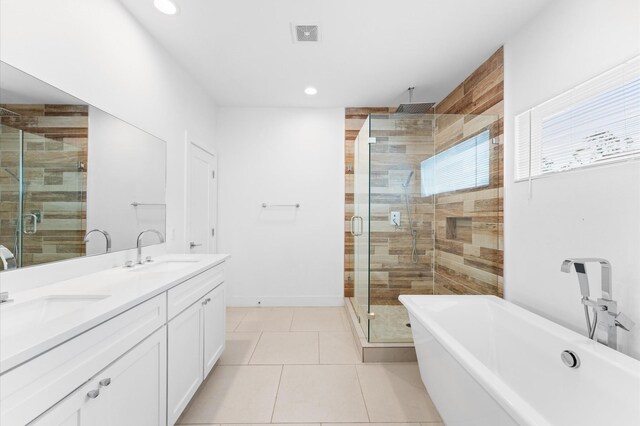 7722 Jacquelyn Oaks Rd, Houston, TX 77055 - bathroom with a shower stall, a soaking tub, double vanity, tile patterned floors, and recessed lighting