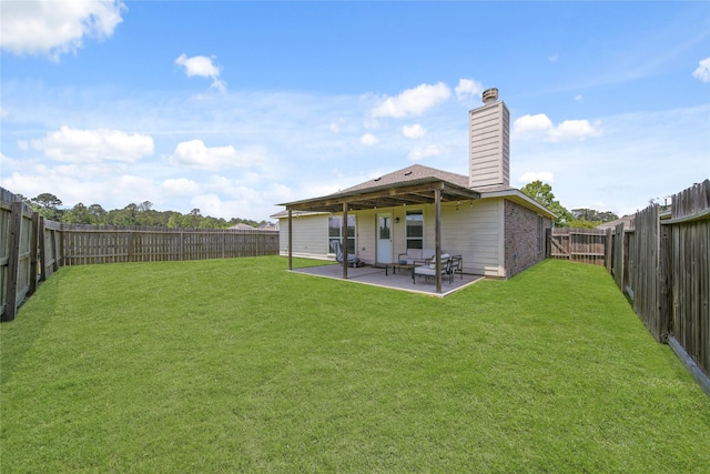 1111 Cypress Ln, Dayton, TX 77535 - rear view of house with a chimney, a patio, and a fenced backyard