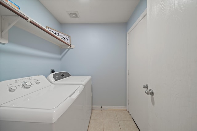 1111 Cypress Ln, Dayton, TX 77535 - laundry area featuring washer and dryer and light tile patterned floors