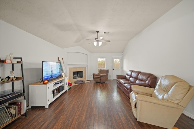 1111 Cypress Ln, Dayton, TX 77535 - living room with a ceiling fan, dark wood-style floors, a fireplace, lofted ceiling, and a textured ceiling