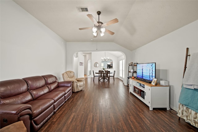 1111 Cypress Ln, Dayton, TX 77535 - living area with arched walkways, dark wood-style floors, a ceiling fan, vaulted ceiling, and a chandelier