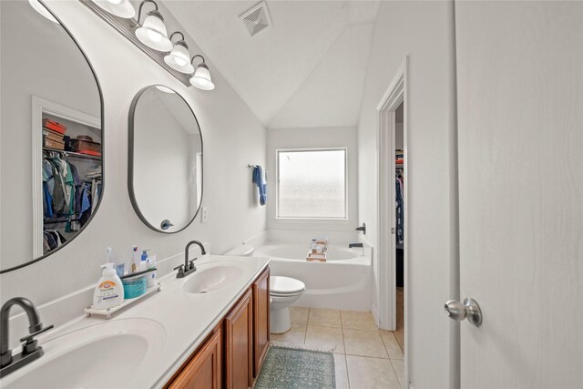 1111 Cypress Ln, Dayton, TX 77535 - full bath featuring a garden tub, a walk in closet, double vanity, lofted ceiling, and tile patterned flooring