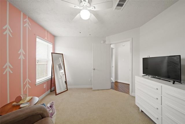 1111 Cypress Ln, Dayton, TX 77535 - bedroom with light colored carpet, ceiling fan, and a textured ceiling