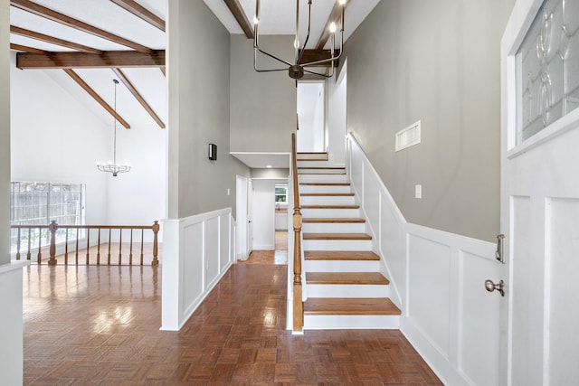 12239 Monticeto Ln, Meadows Place, TX 77477 - stairway with a chandelier, high vaulted ceiling, healthy amount of natural light, beamed ceiling, and wainscoting