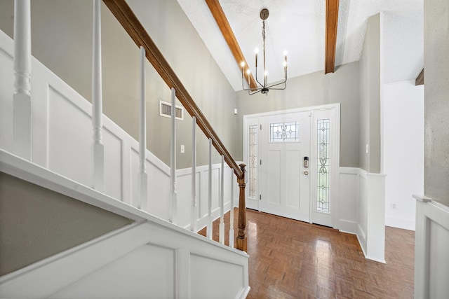 12239 Monticeto Ln, Meadows Place, TX 77477 - entrance foyer with beamed ceiling, stairway, a wainscoted wall, high vaulted ceiling, and a chandelier