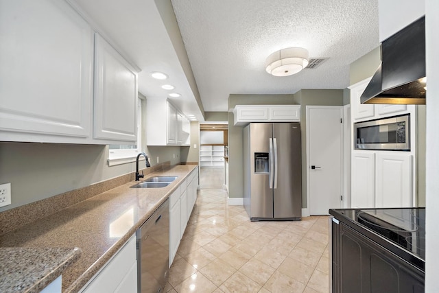 12239 Monticeto Ln, Meadows Place, TX 77477 - kitchen with appliances with stainless steel finishes, custom range hood, white cabinetry, stone countertops, and light tile patterned flooring